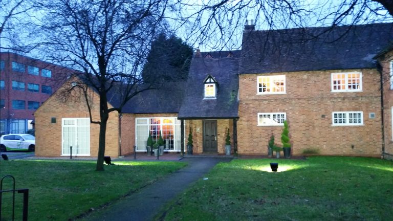 Completed LED exterior lighting installation illuminating a historic building in Solihull after dark.