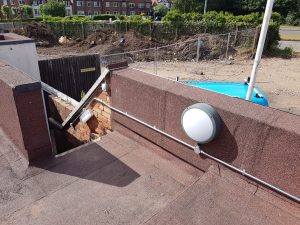 Emergency bulkhead light installed to illuminate an external staircase and escape route.