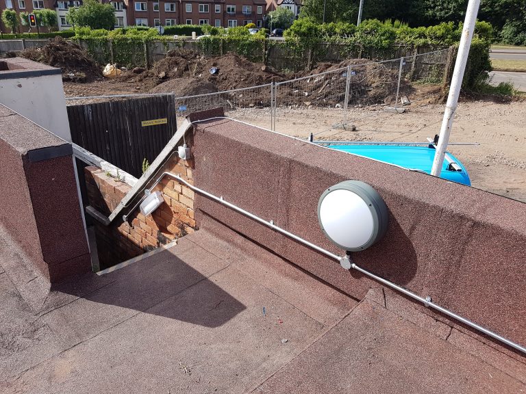 Emergency bulkhead light installed to illuminate an external staircase and escape route.