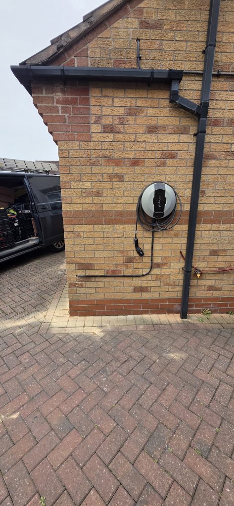 Completed domestic EV charger installation with neatly routed external cabling and dedicated EV charging point.