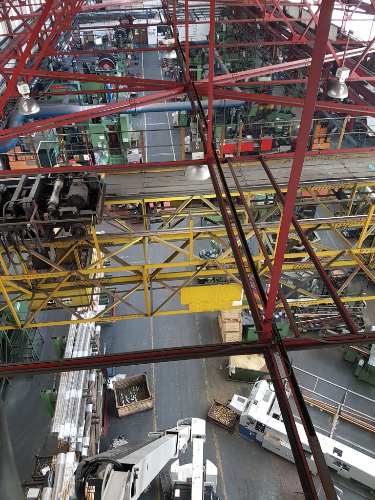 Industrial manufacturing facility with heavy production machinery and factory equipment.