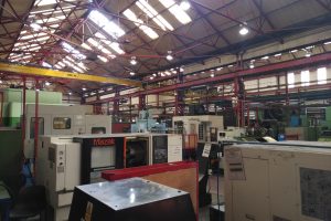 Industrial machine shop where 400 W metal halide lamps were upgraded to high-output LED corn light retrofits, reducing energy consumption and maintenance.