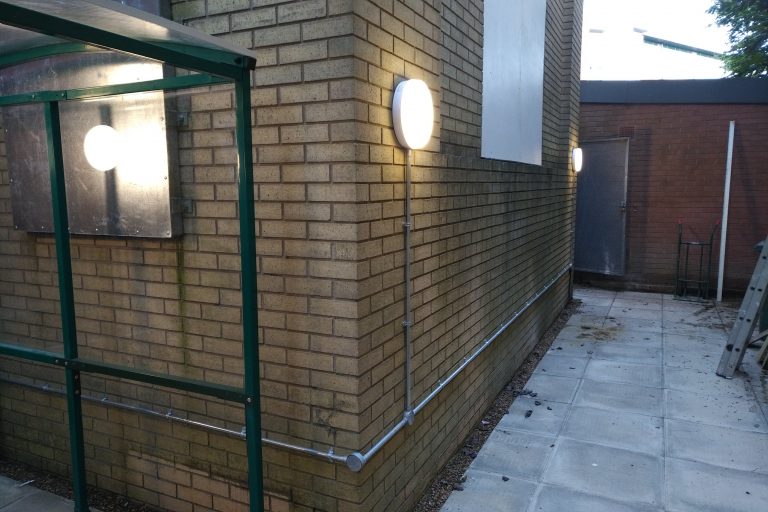 Completed Commercial External Lighting Installation with LED bulkhead lighting and steel conduit containment.