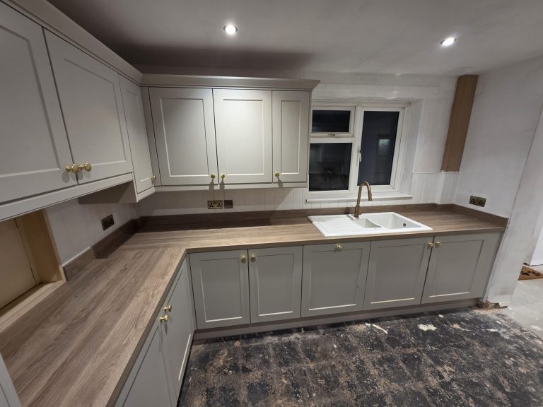 New electrical sockets installed level around a kitchen during a domestic rewire.